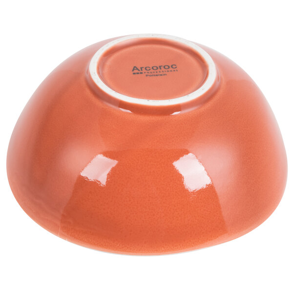 An orange Arcoroc Canyon Ridge bowl with a white rim.