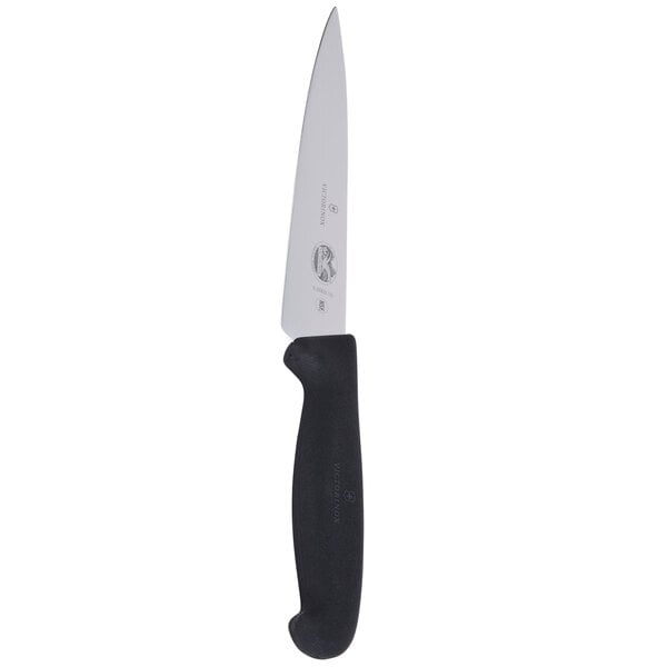 A Victorinox chef knife with a black handle and a white blade.