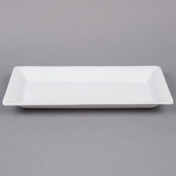 A white rectangular American Metalcraft stoneware platter with a white rectangular plate on it.