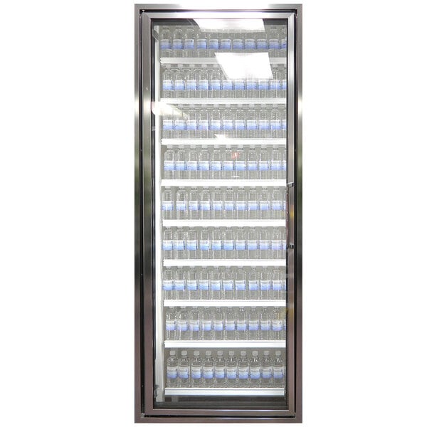 A Styleline walk-in cooler merchandiser door with shelving filled with water bottles.