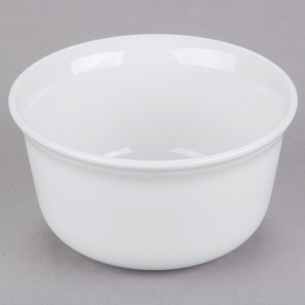 A white Cambro porcelain bowl on a gray surface.