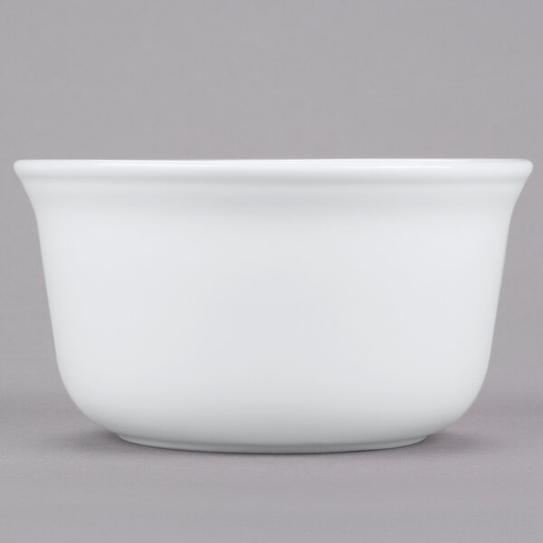 A white bowl on a gray surface.