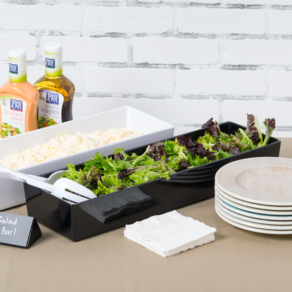 A Tablecraft black melamine bowl filled with salad on a salad bar.