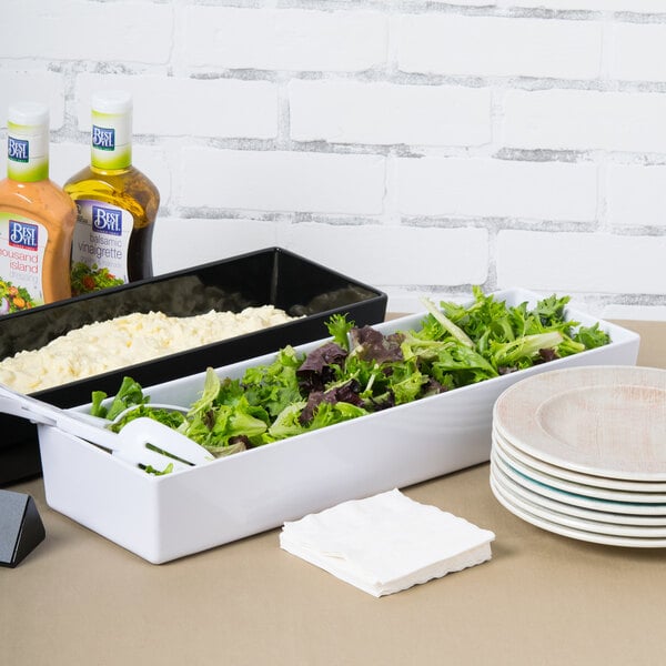 A white Tablecraft melamine bowl filled with salad on a table.