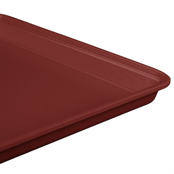 A close-up of a burgundy MFG Fiberglass Supreme Display Tray.