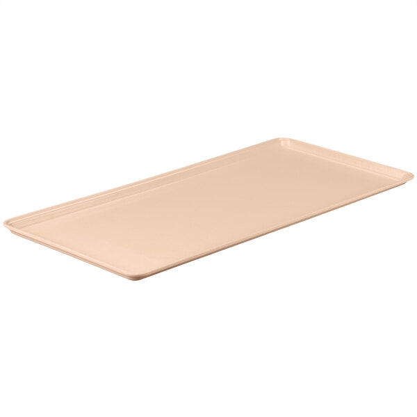 A peach rectangular fiberglass MFG Tray on a white counter.