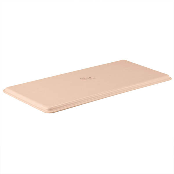 A rectangular peach fiberglass MFG Tray with a logo on it.