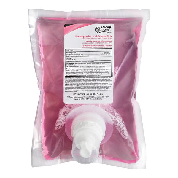 A clear plastic pouch filled with pink liquid soap, featuring a white dispensing nozzle and a label with product information.