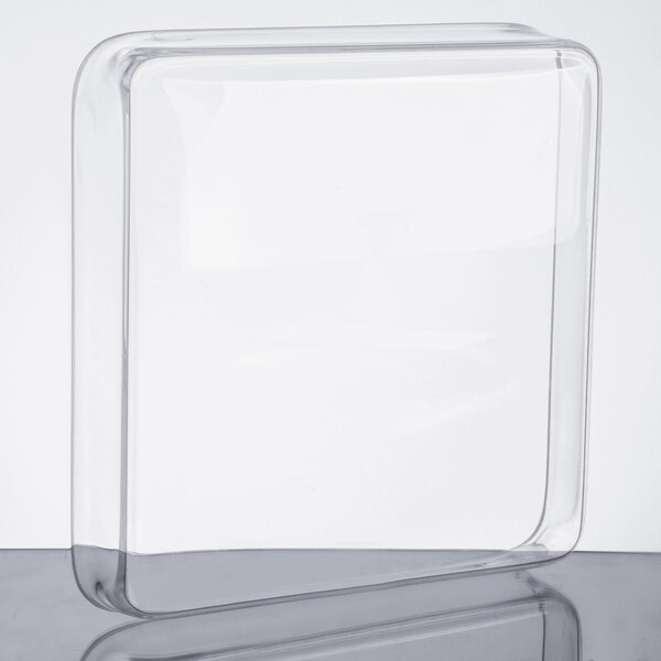 A clear plastic lid for a clear square beverage dispenser.