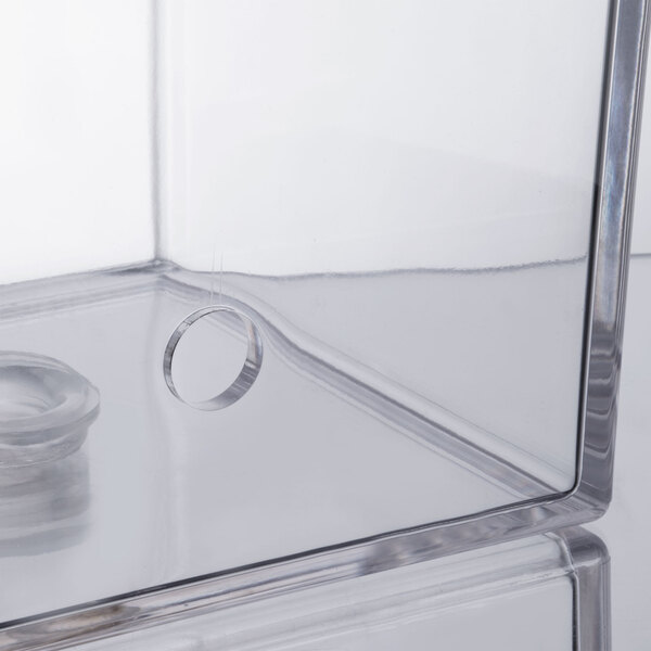 A clear plastic box with a ring inside.