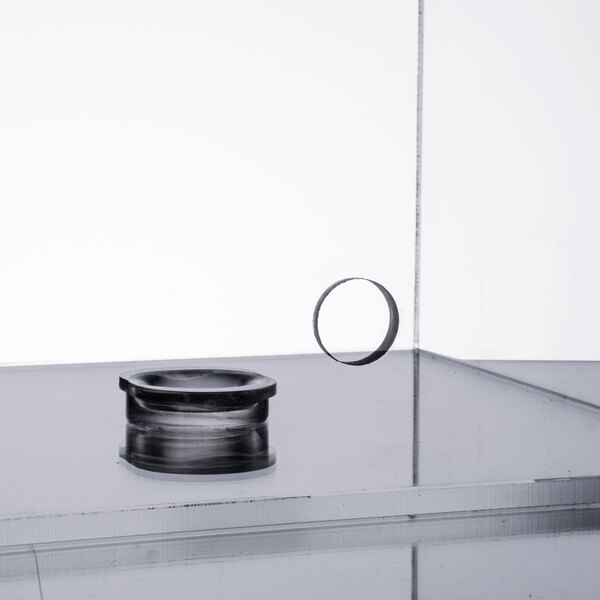 A Cal-Mil 5 gallon beverage dispenser chamber on a glass table.