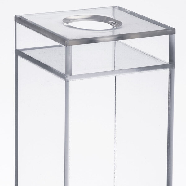 A clear plastic box with a hole in the top.