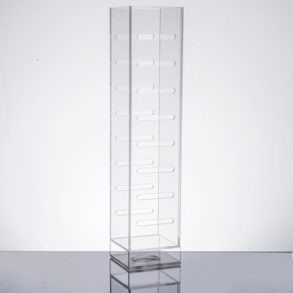 A clear plastic infusion chamber on a table.