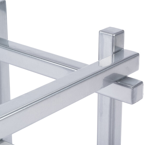 A close-up of a silver metal beverage dispenser base.