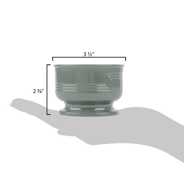 A hand holding a Cambro Shoreline Meadow bowl with measurements.