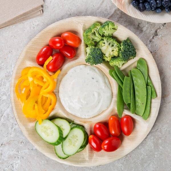 Fresh vegetables and vegetable dip on an eco-friendly tray