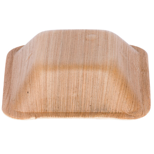 A close up of an EcoChoice square palm leaf bowl.
