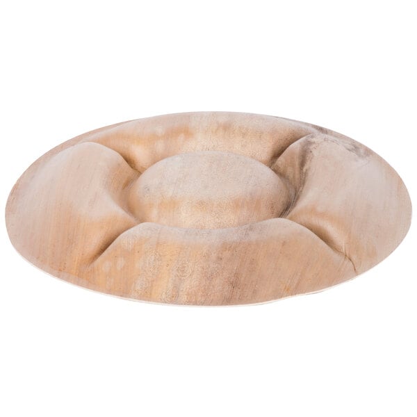 An EcoChoice palm leaf deli tray with a circular design carved into it.