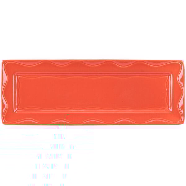 A Libbey Cantina rectangular tray with a wavy design in orange porcelain.