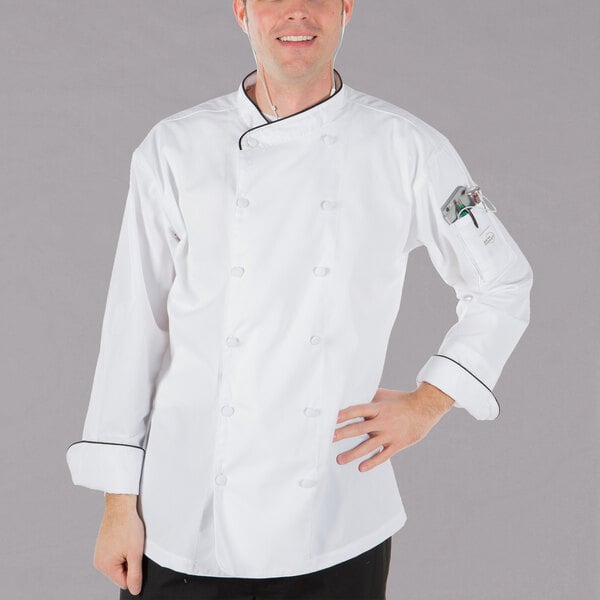 A man wearing a white Mercer Culinary chef jacket with black piping.