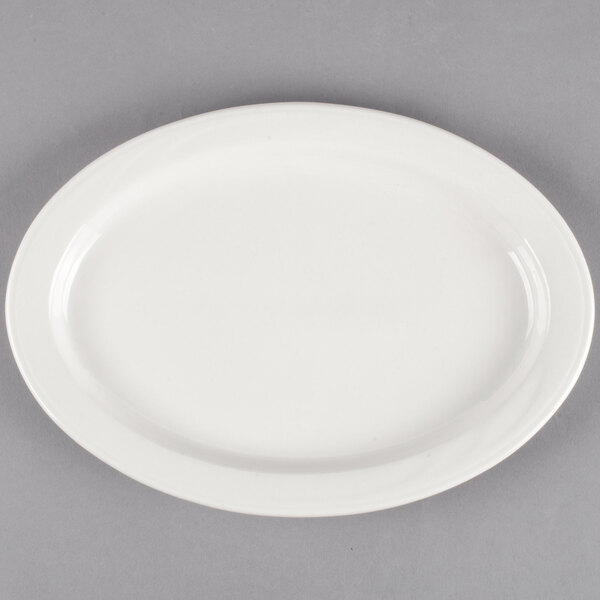 A white oval medium rim porcelain platter on a gray background.