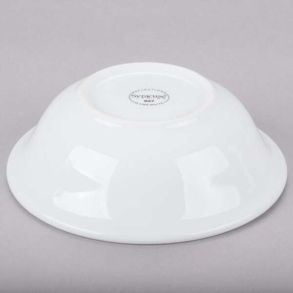 A Libbey white porcelain grapefruit bowl on a gray surface.