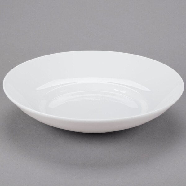 A white Libbey porcelain pasta bowl with a circular pattern on a gray surface.