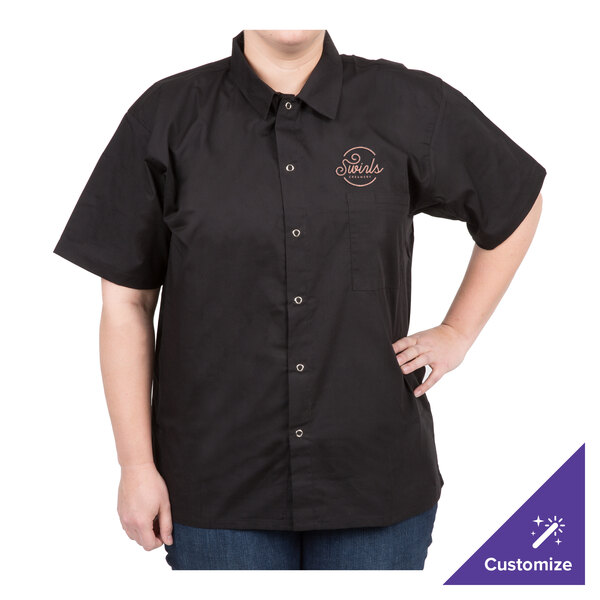 A woman wearing a black Chef Revival cook shirt with a logo on it.