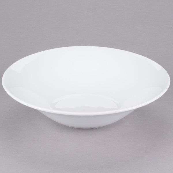 A Libbey white porcelain serving bowl on a gray surface.