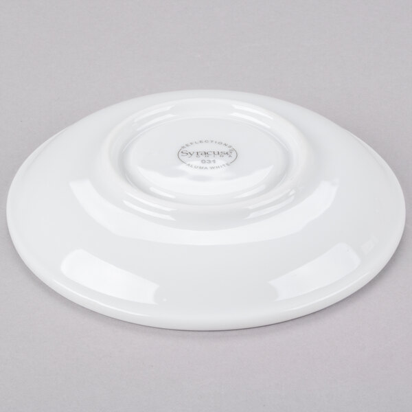 A white Libbey porcelain tea saucer with a logo on it.