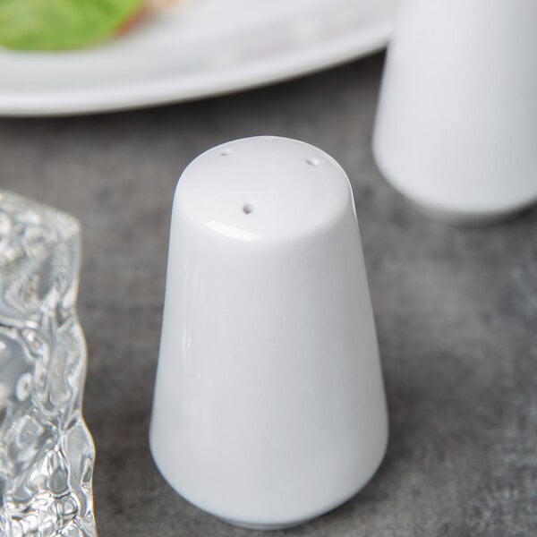 A white Libbey porcelain salt shaker with a black top.