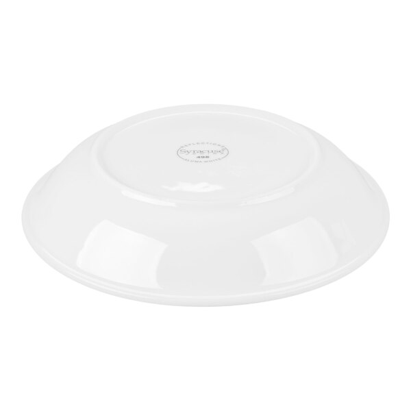A white shallow bowl is shown upside down, displaying its smooth, glossy surface and a circular stamp or logo at the center of the base.