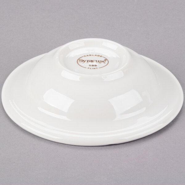 A white Libbey porcelain fruit bowl with a brown circle on it.