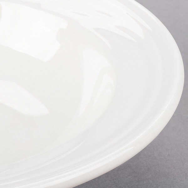 A Libbey ivory porcelain fruit bowl with a rim.