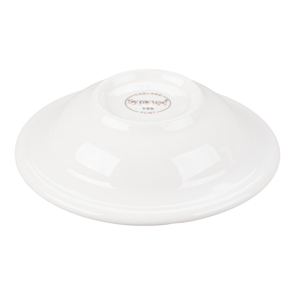 A white porcelain bowl shown upside down with a manufacturer's mark on the bottom.