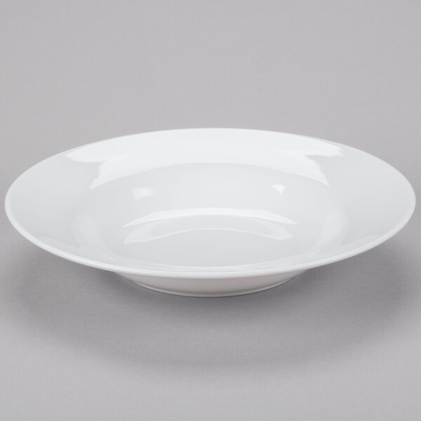 A Libbey white porcelain pasta bowl on a gray surface.