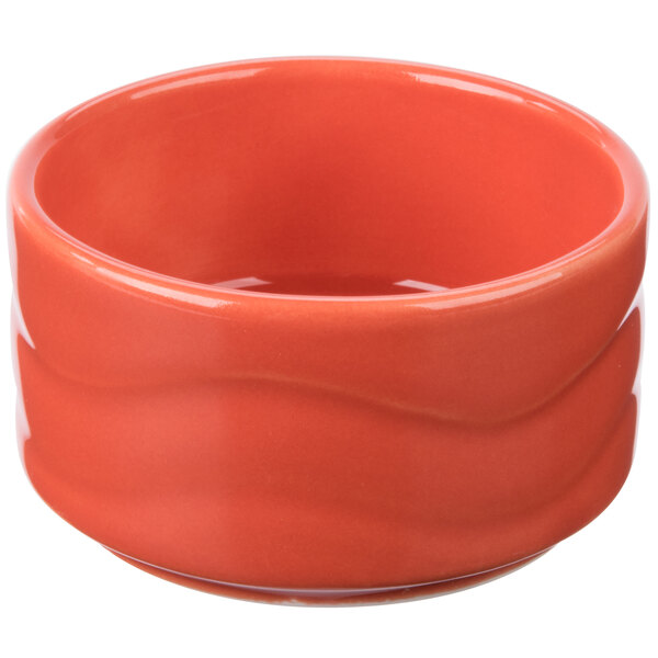 A Syracuse China Cantina porcelain bowl with a red rim and white line on the surface.