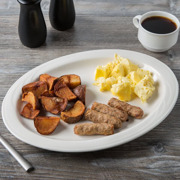 An ivory porcelain platter with food and a cup of coffee on a wood table.