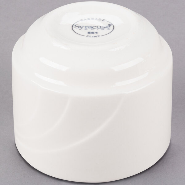 A white round Libbey porcelain bouillon cup with a logo on it.