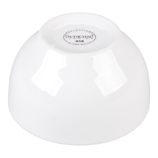 A white porcelain bowl shown upside down with a label on the bottom.