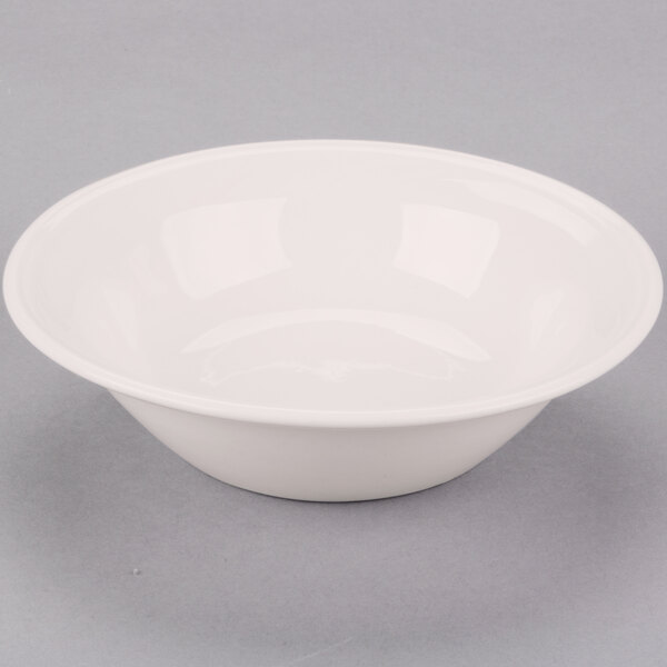 A white Libbey Cascade grapefruit bowl on a gray surface.