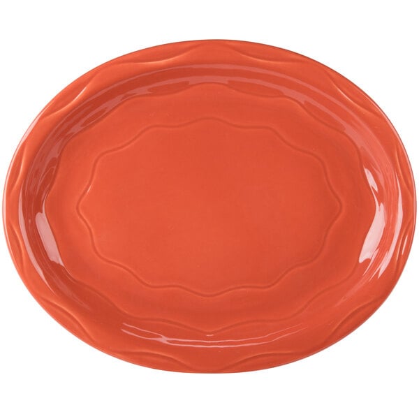 An orange oval Libbey porcelain platter with a design on it.
