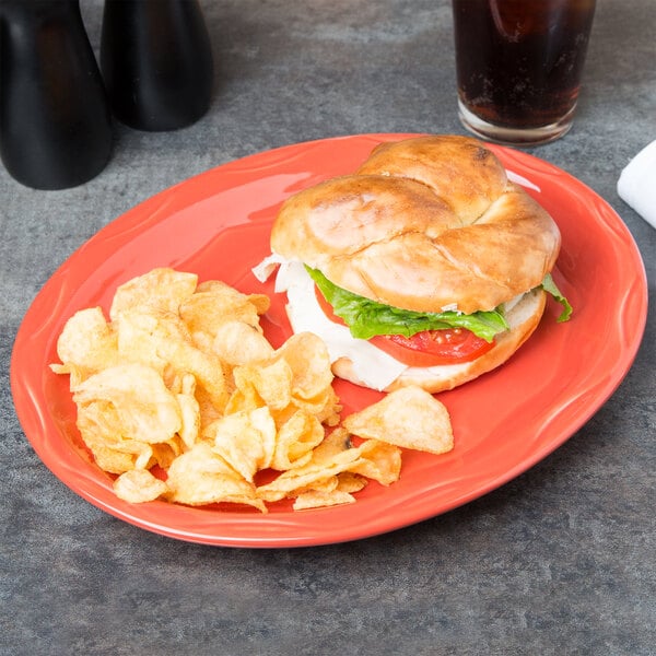 A sandwich and potato chips on a Libbey Cayenne carved porcelain oval platter.