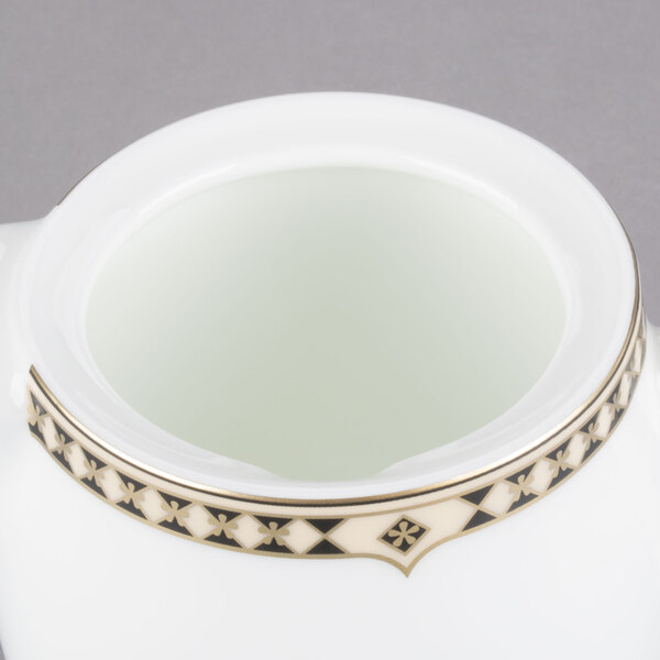 A white bone china teapot with gold trim.