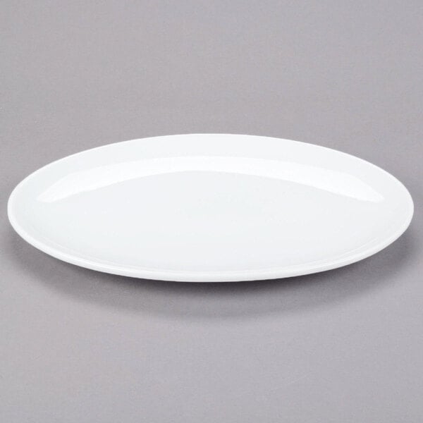 A white oval Libbey porcelain coupe platter on a gray surface.