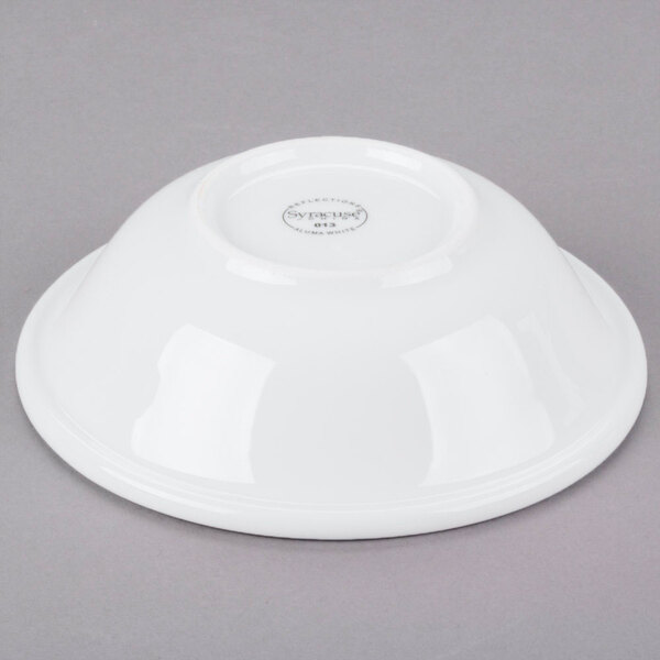 A white Libbey porcelain cereal bowl on a gray surface.