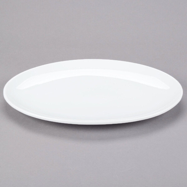 A white oval Libbey Aluma White porcelain platter on a gray surface.