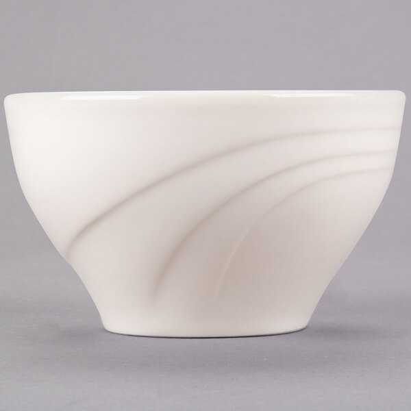 A Libbey ivory round porcelain bowl with a curved design.