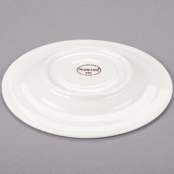 A Libbey ivory porcelain tea saucer with a medium rim.