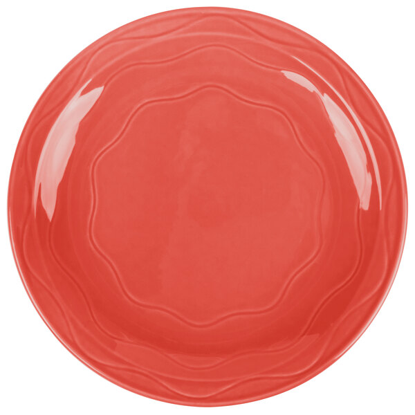 A red Libbey Cayenne porcelain plate with a wavy circular design.